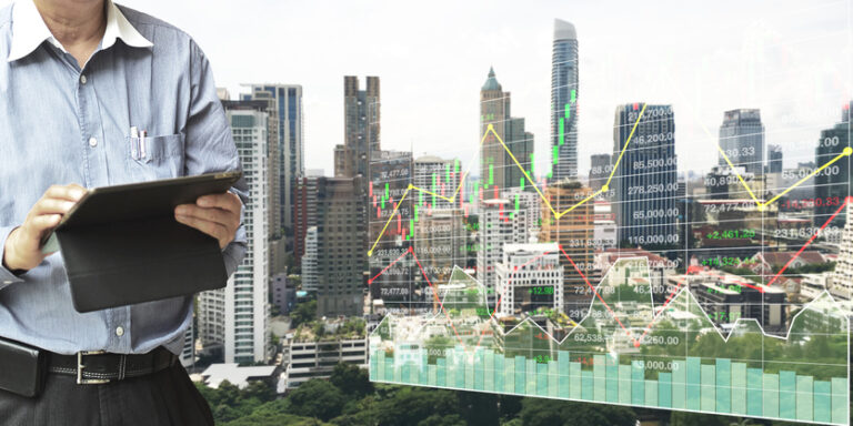 Businessman Standing And Operate Tablet To Control And Connect Big Data Of Real Estate Sector Stock Market Index With Chart And Graph Background.